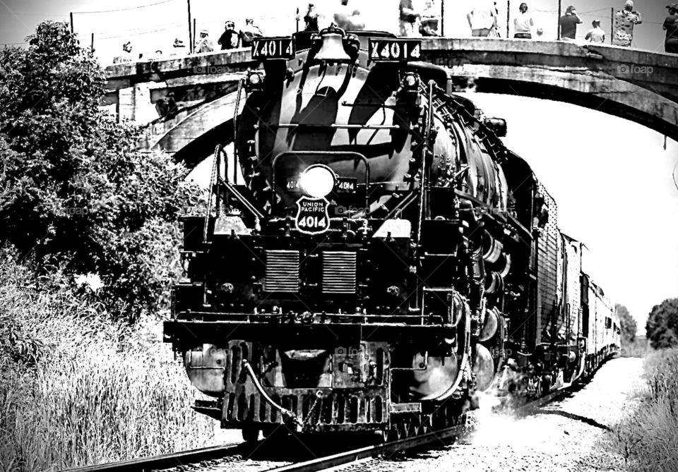 Union pacific built in 1907 came out to say hello to from below the bridge view. Beautiful Black and white photo of the train. if you look closely you can even see the smoke coming off the track. where is the train is leaving and not coming back.