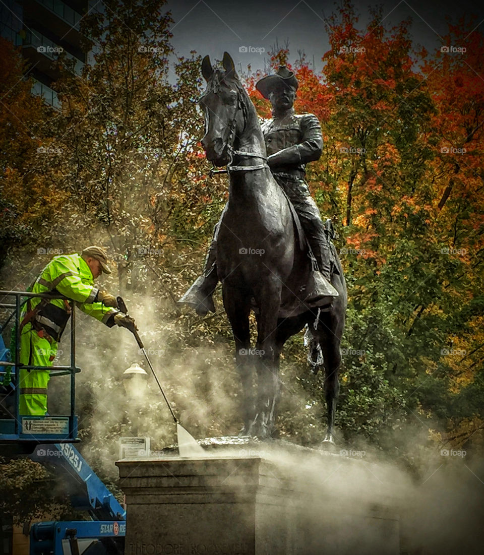 Cleaning a statue of Theodore (Teddy) Roosevelt on horseback on the South Park Blocks in Portland, Oregon