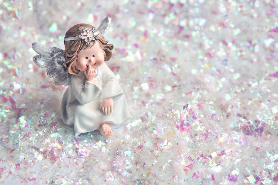 toy angel on a background of artificial snow
