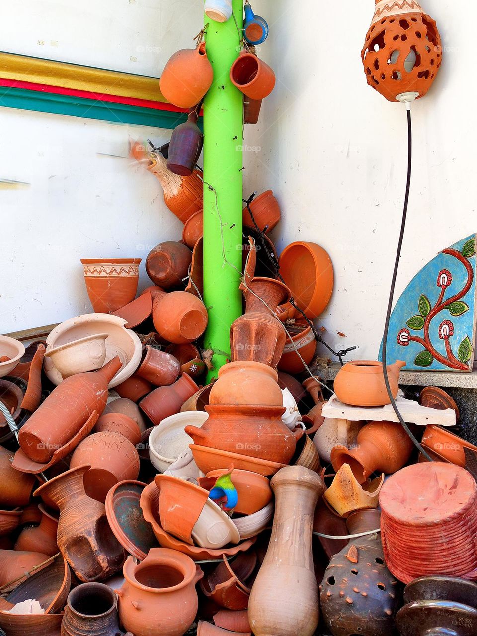 Urban art.  Entrance to the pottery workshop.  In the corner lies a pile of various vessels made of clay