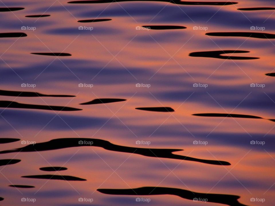 Water with Sunset colours  (Praia - Italy ).