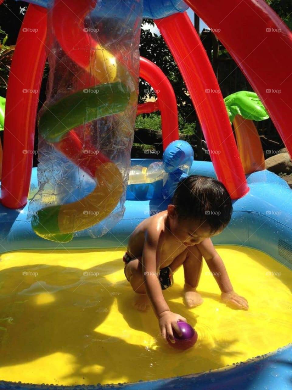 A little boy enjoys the water