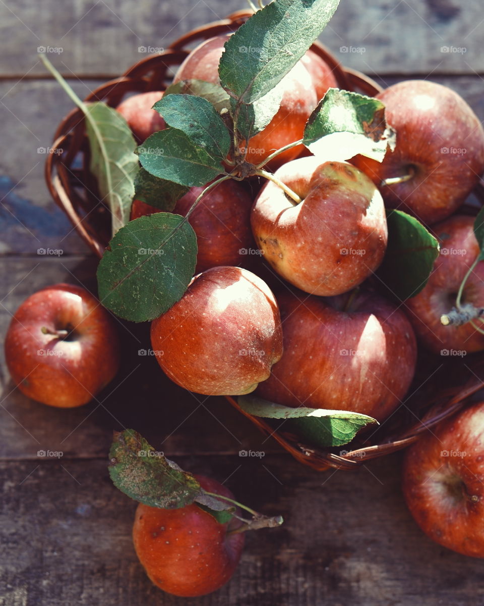 Apples in basket on table