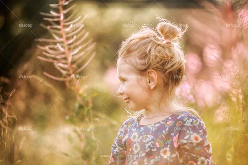 Little girl outdoor portrait in sunlight