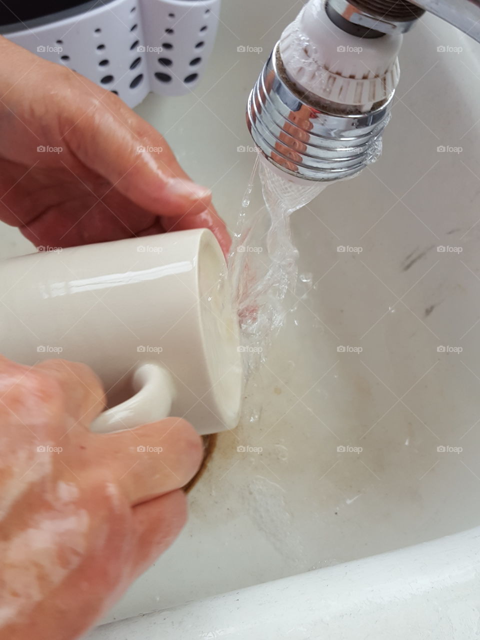 Women washing cup in kitchen