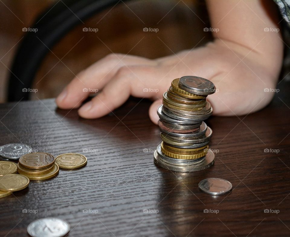 child hands and coins playing, metal objects