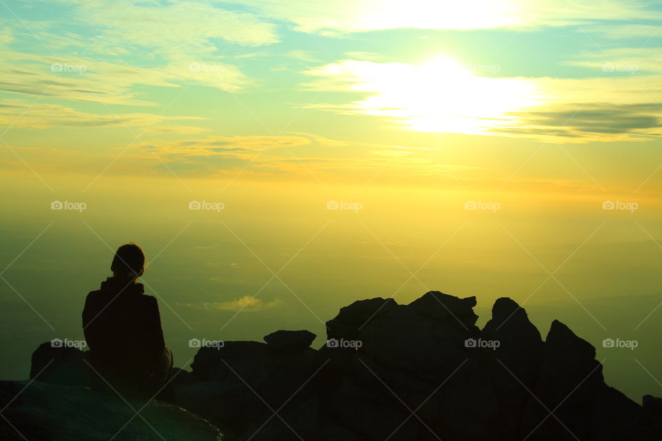 golden sunset. woman relaxing at sunset in the mountains of cordoba, argentina