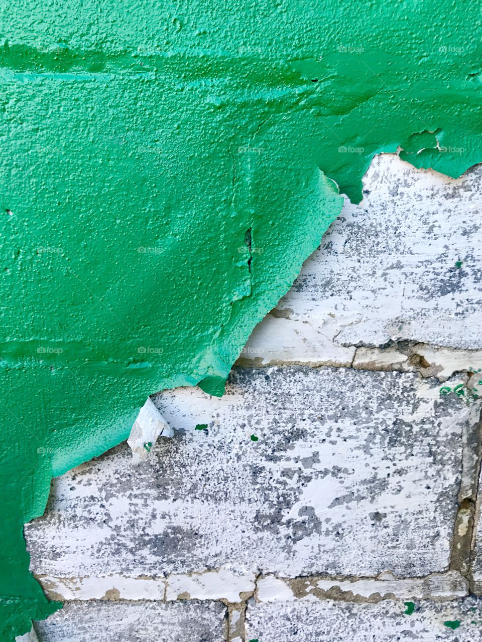 Green Paint Peeling from Stone Wall