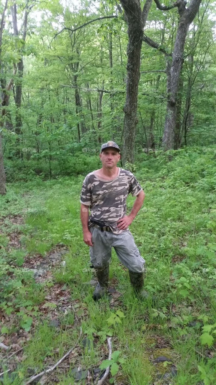 Military man standing in forest