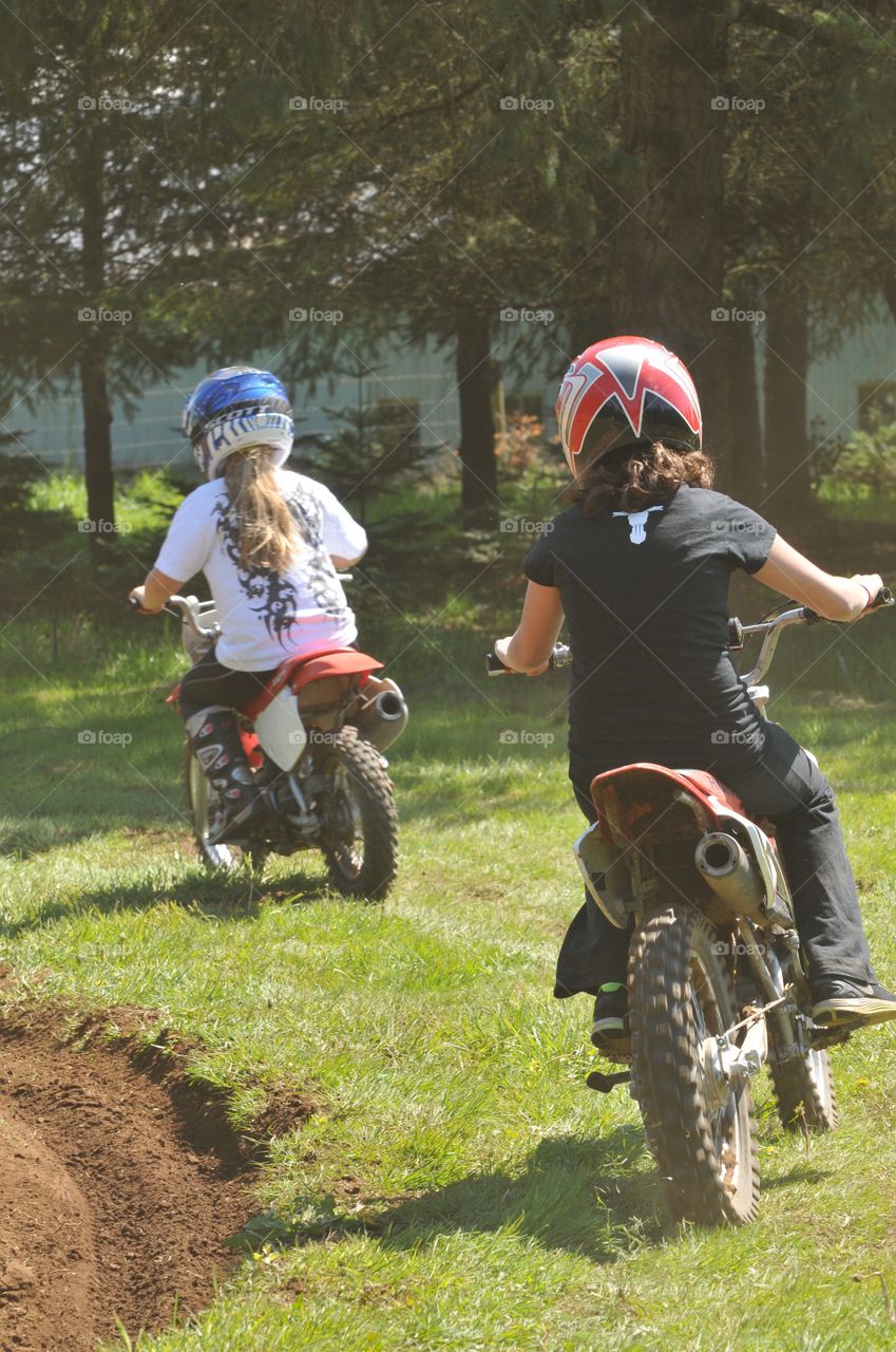 Summer Fun. Riding dirt bikes in the backyard