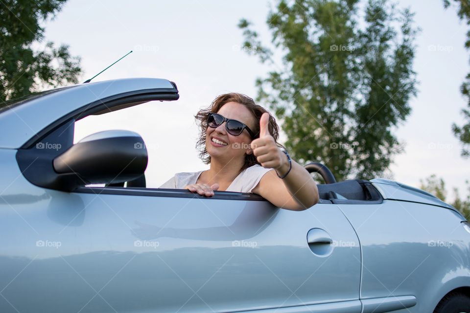 Young woman with thumbs up