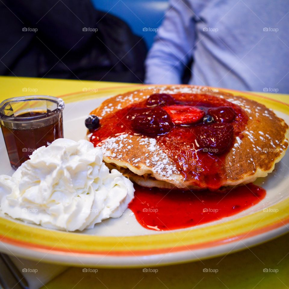 Pancakes with berry syrup and cream