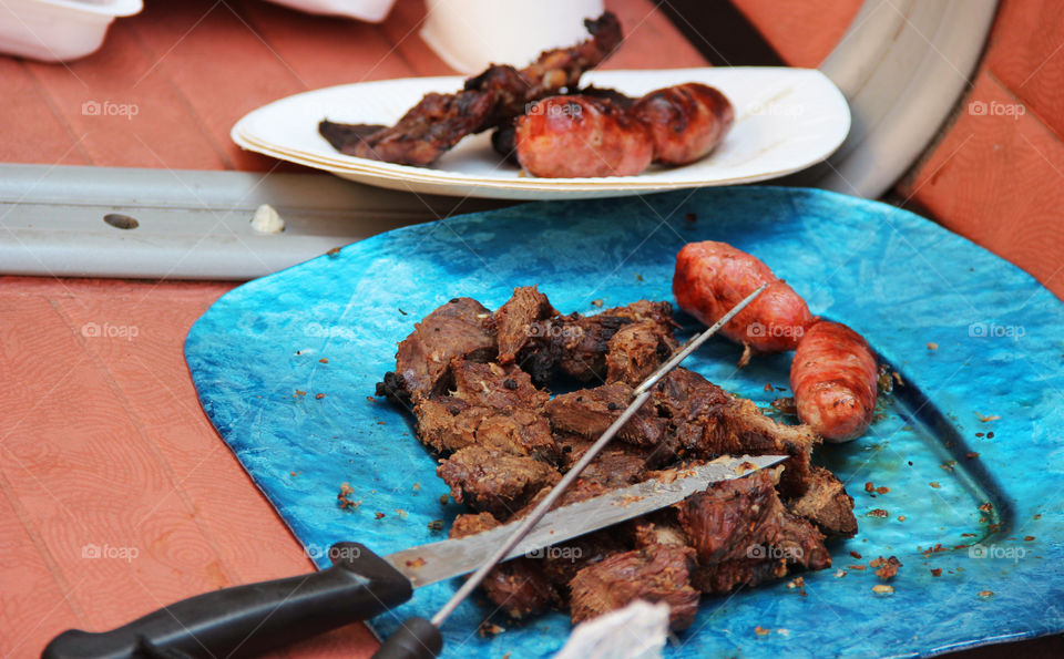 Meat on plate with knife