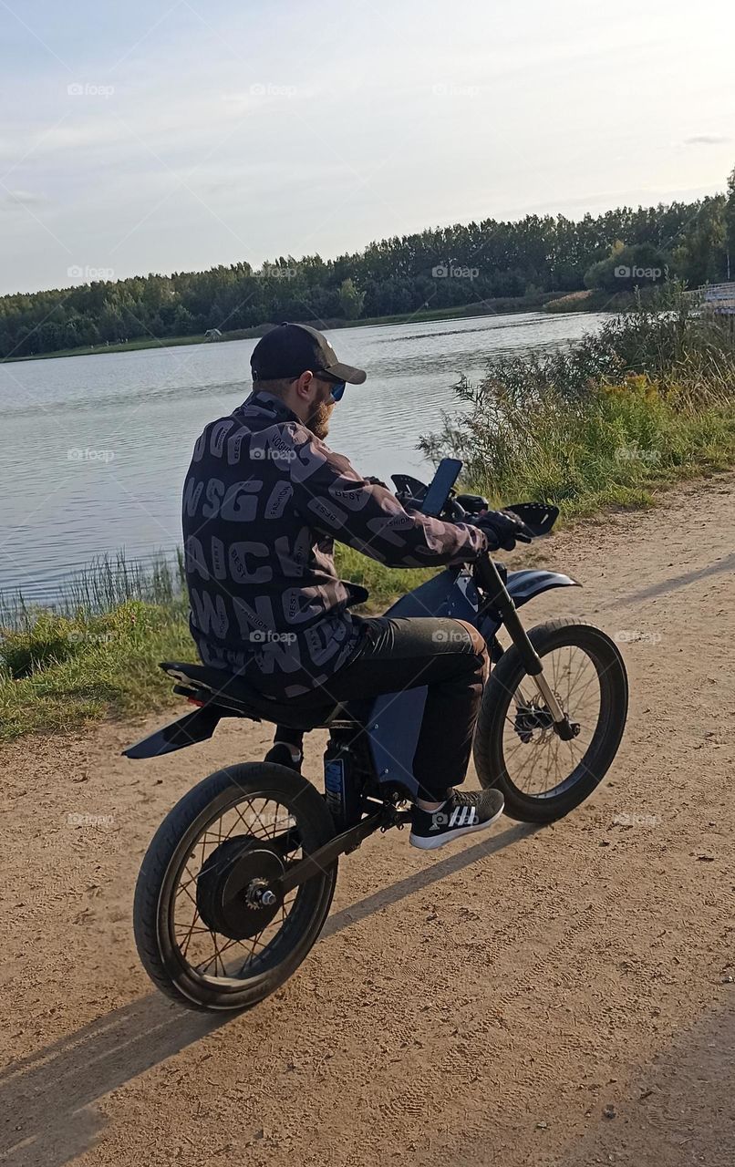 men on a electric motorcycle, summer time