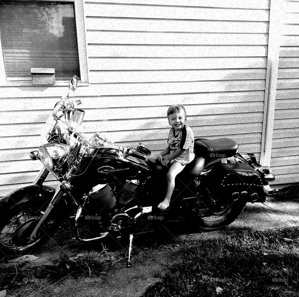 boy sitting on a motorcycle