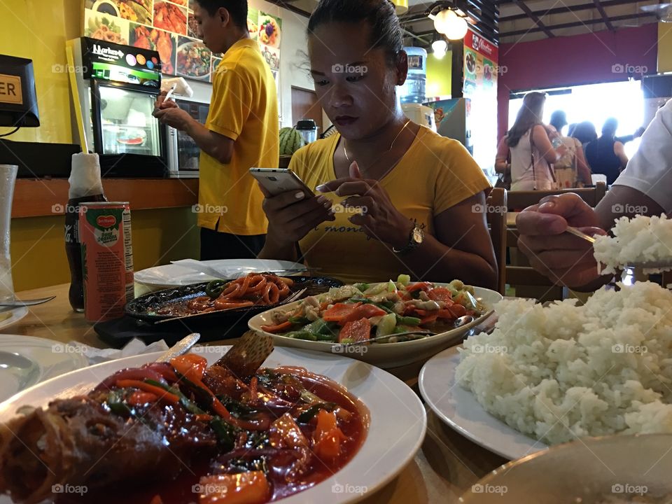 Using phone at the restaurant