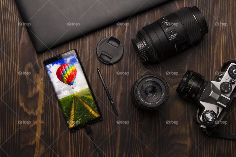 Top view of photography accessories and smartphone with stylus.  Foap concept