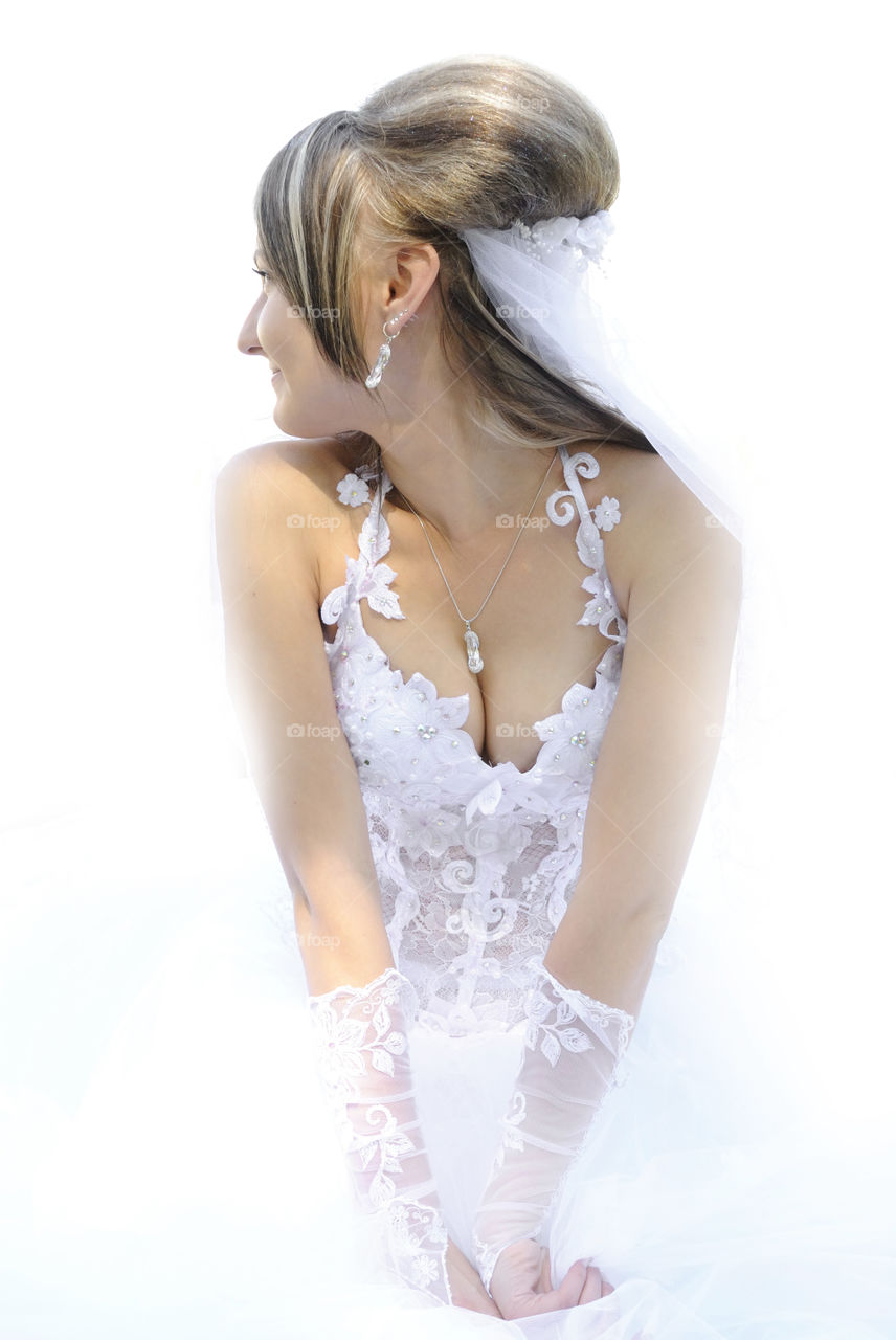 Woman in wedding dress on white background