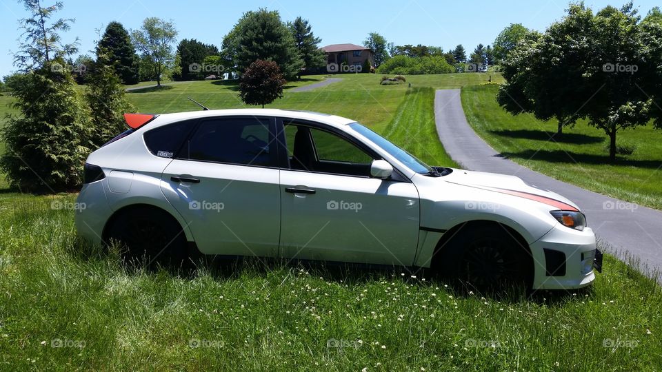 My baby in the lawn. snapped a photo of my Subaru WRX when at a friends place.