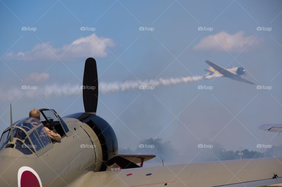 Warbirds take to the sky for this war re-enactment at Air Venture at EAA