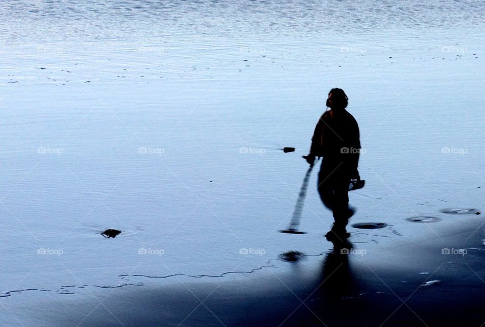 Metal detector man on beach