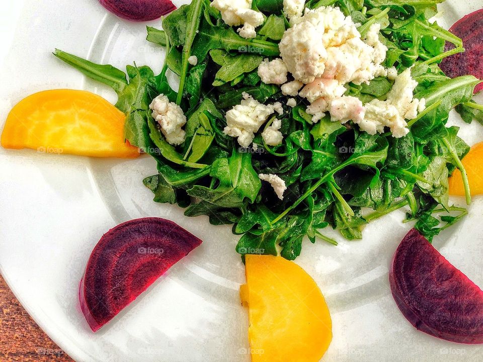 Red and gold beets in a salad with goat cheese