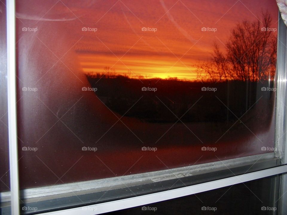 Sunrise looking through a window on a winter morning. 