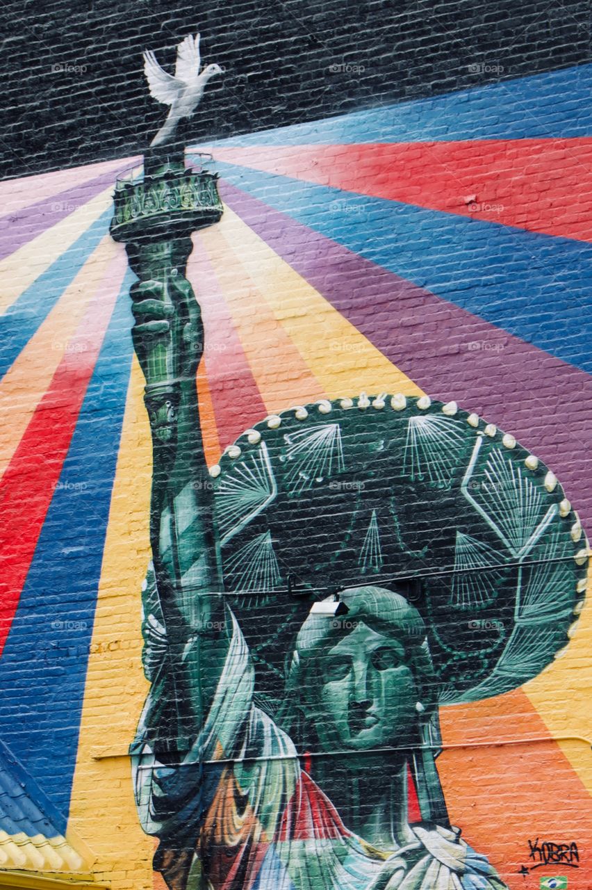 Statue of Liberty painted on a brick wall 