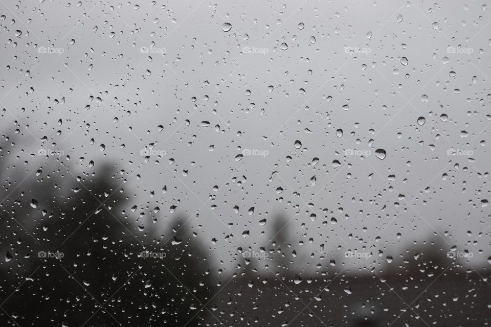 Water droplets on window on a bad weather day.