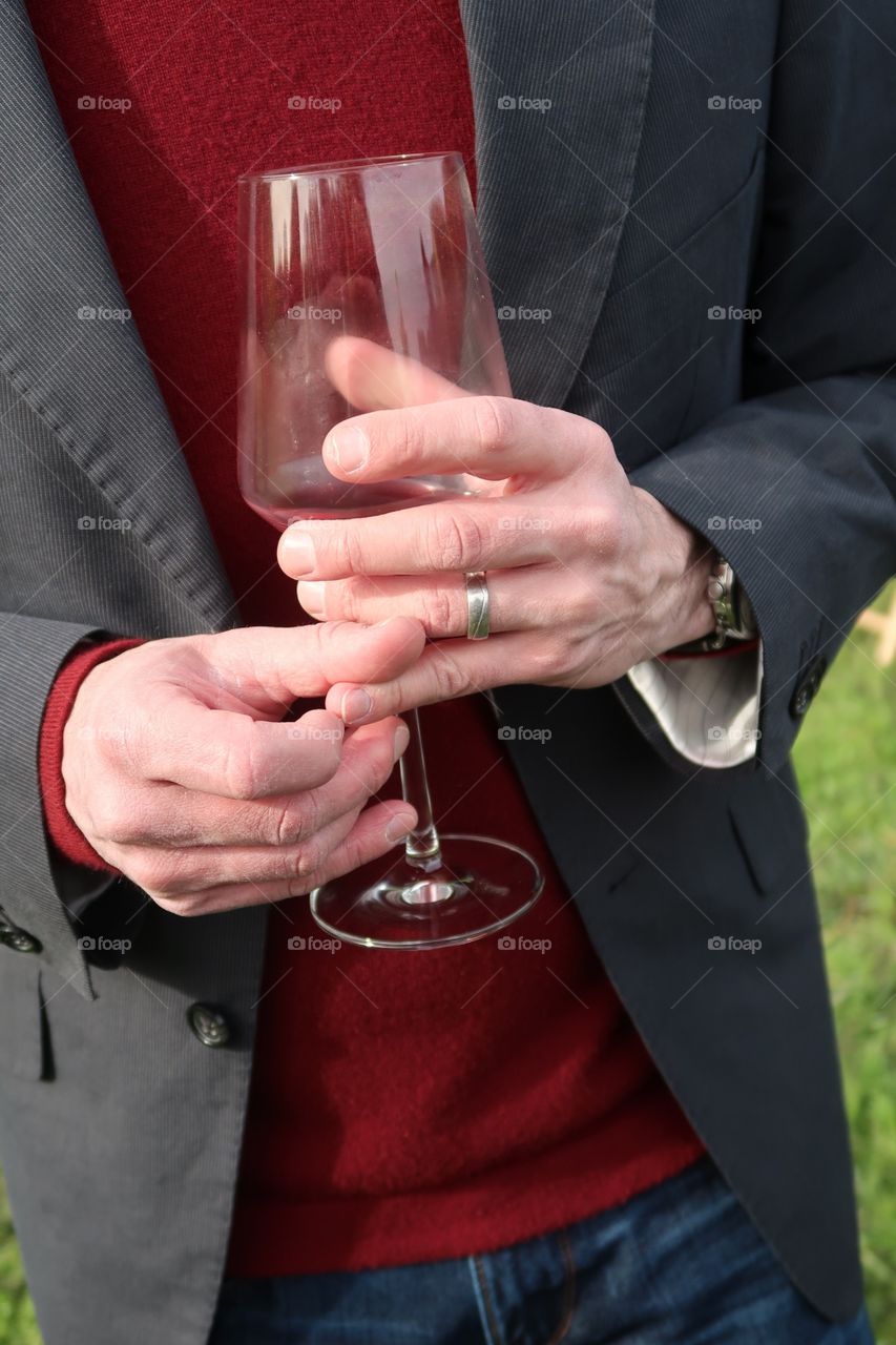 Hands holding a glass of wine 