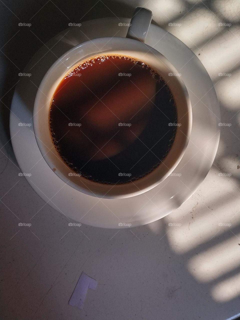 A cup of coffee with shadow