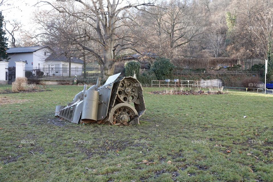 Artistic installation of the rear part of a tank sinking into the ground in Prague on Kinsky Square. A reminder of the occupation of the Czech Republic by Soviet troops.