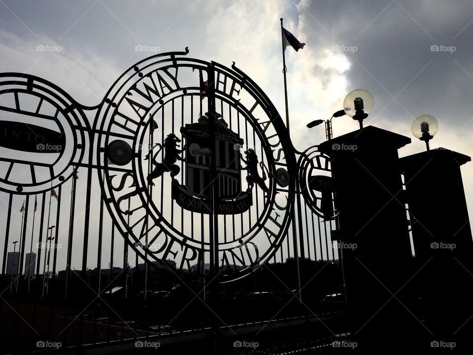 Stadium of Light Silhouette . Silhouette of the gates at the Stadium of Light in Sunderland with SAFC badge and slogan. 