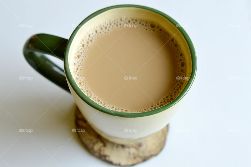 Mug of coffee on a wooden coaster