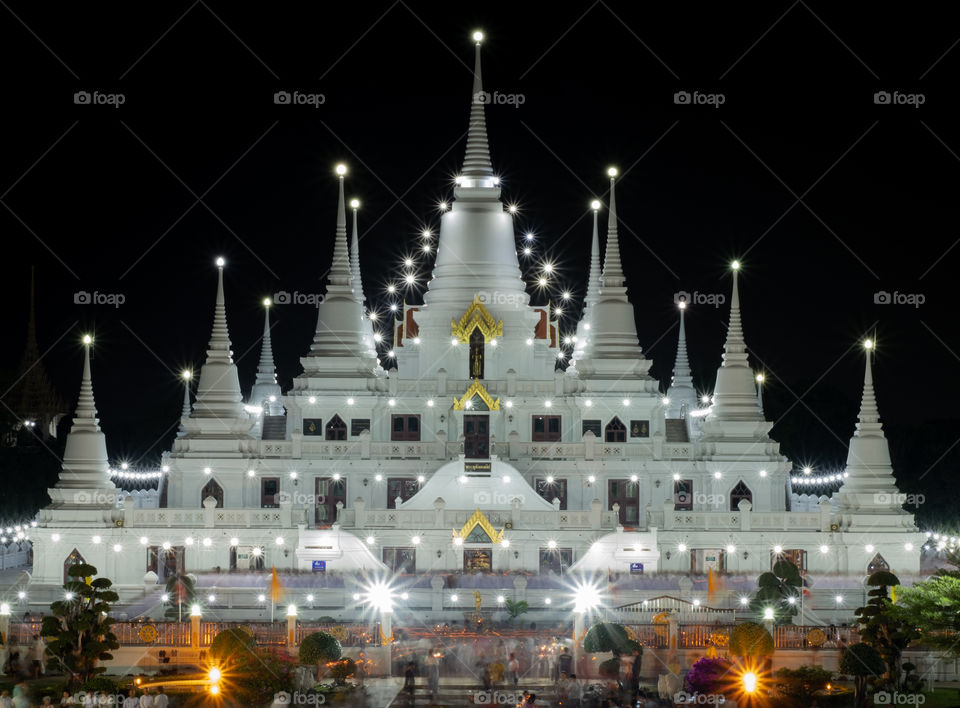 Thailand-Febuary 08 2019:Line of Monks walk around the pagoda with candle at Wat Asokkaram in Magha Puja Day is held on the Day of the full moon of the third lunar month 