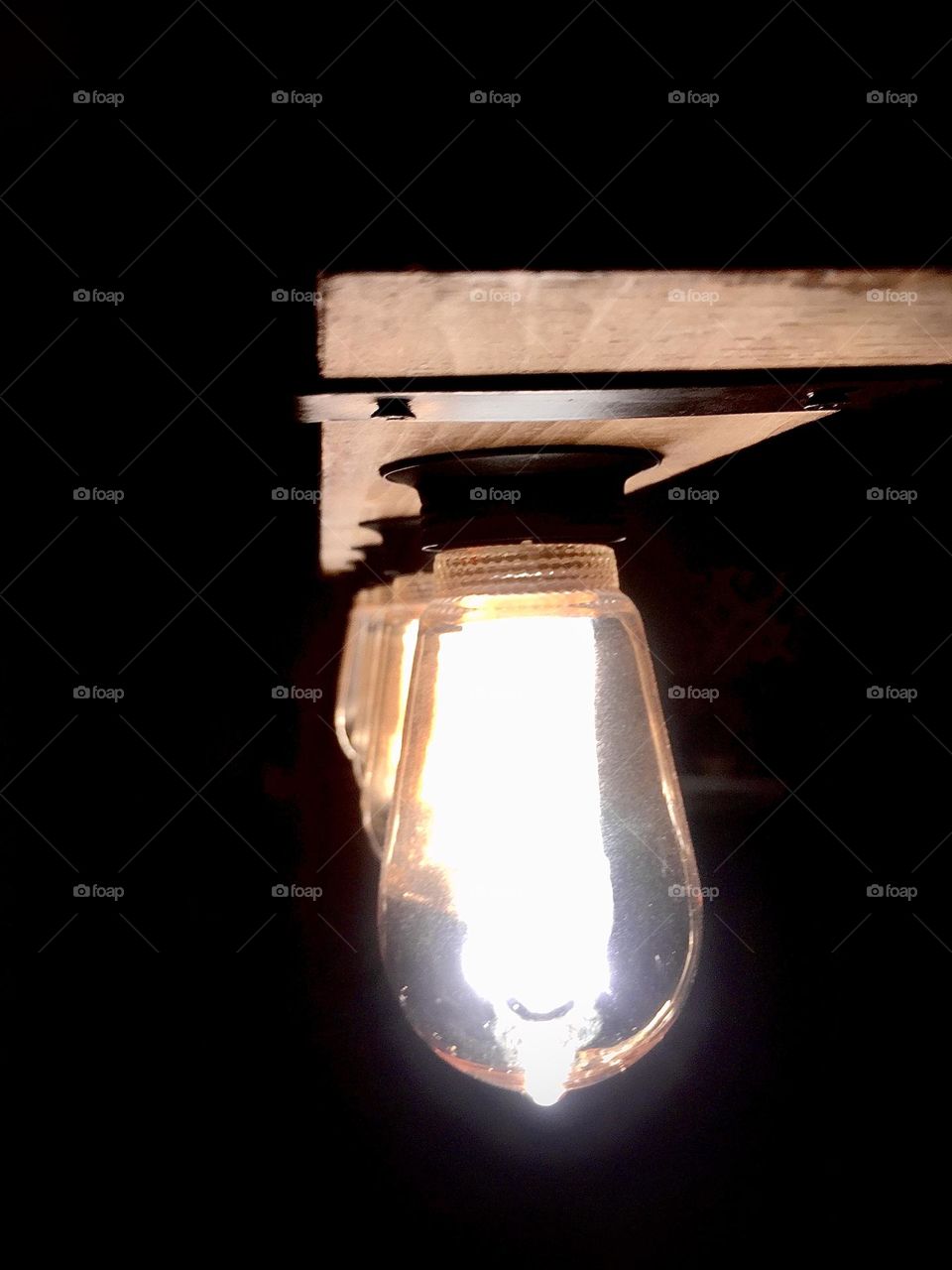 Wooden light feature with iron strips holding it in place