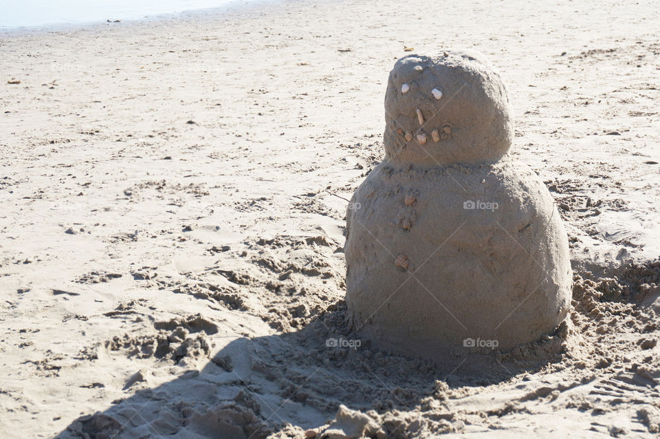 Sand snowman on the beach in Spain