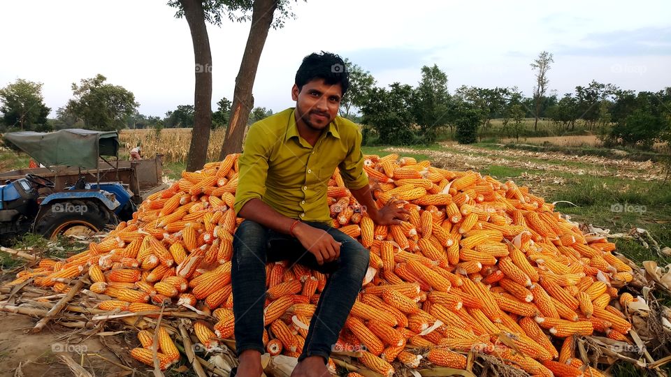 happy farmer with maize