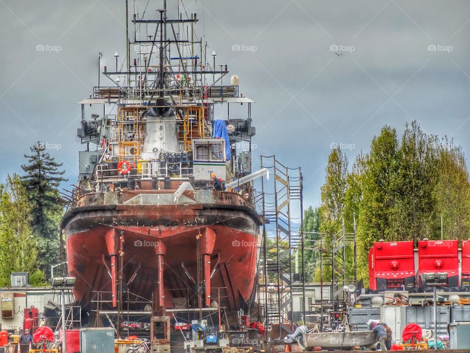Ship Undergoing Construction In Drydock. Ship In Dry Dock
