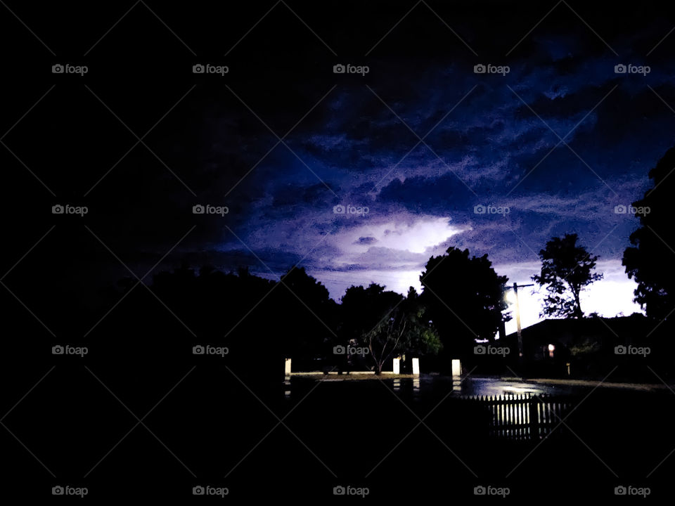 Street with lighting flash in the background.