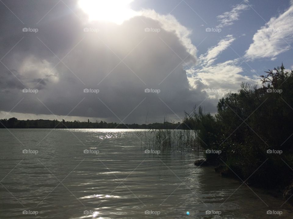 Clouds and sun on the lakeside 