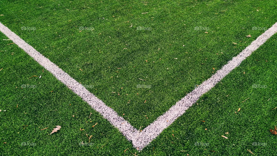 white markings on the green grass of a football field