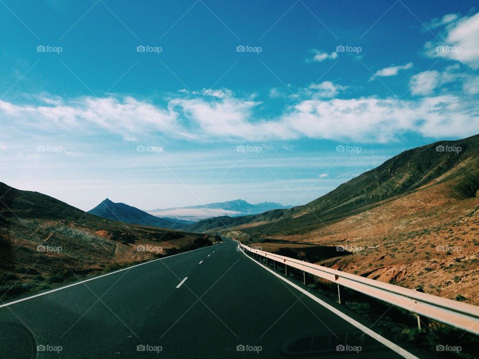 Empty road along with mountains