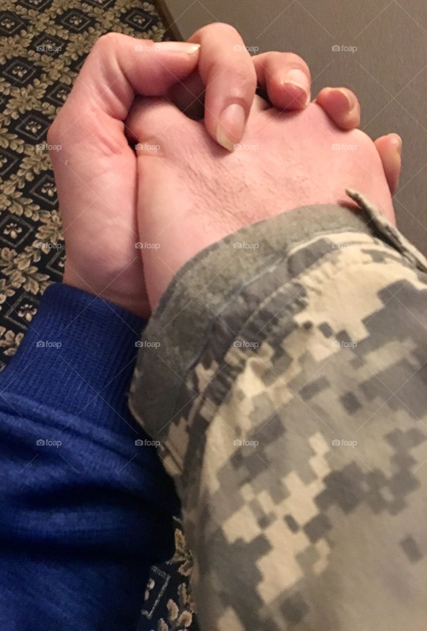 Civilian holding hands with a soldiers