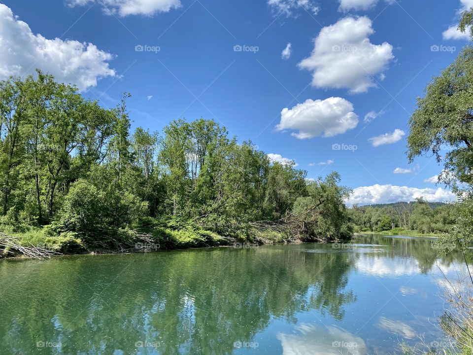 water landscape grass and clouds