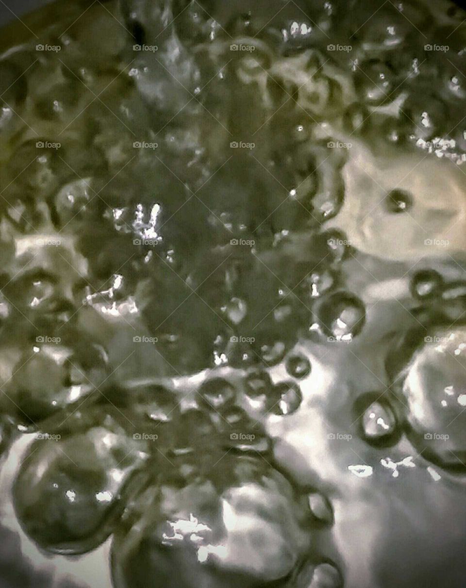 Close-up of Water Overflowing in a Mason Jar (top view)