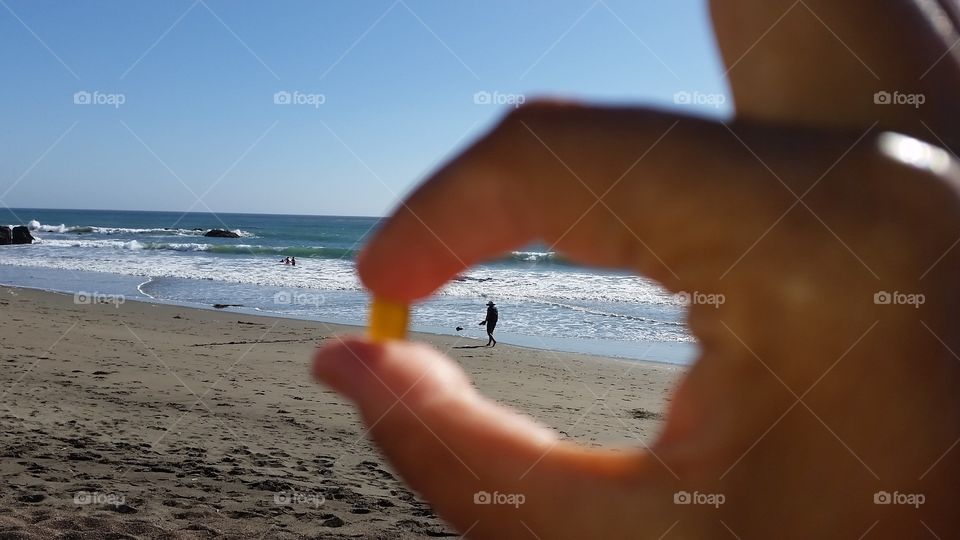 Photographer's prespective. Looking for the perfect pebbleb on a beach.