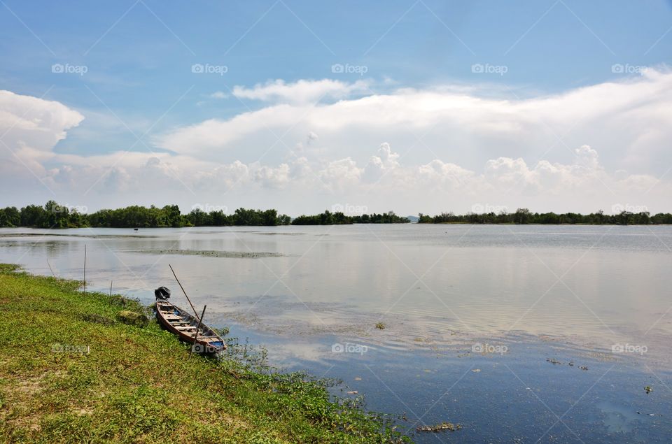 Lake view,boat and reflection of sky