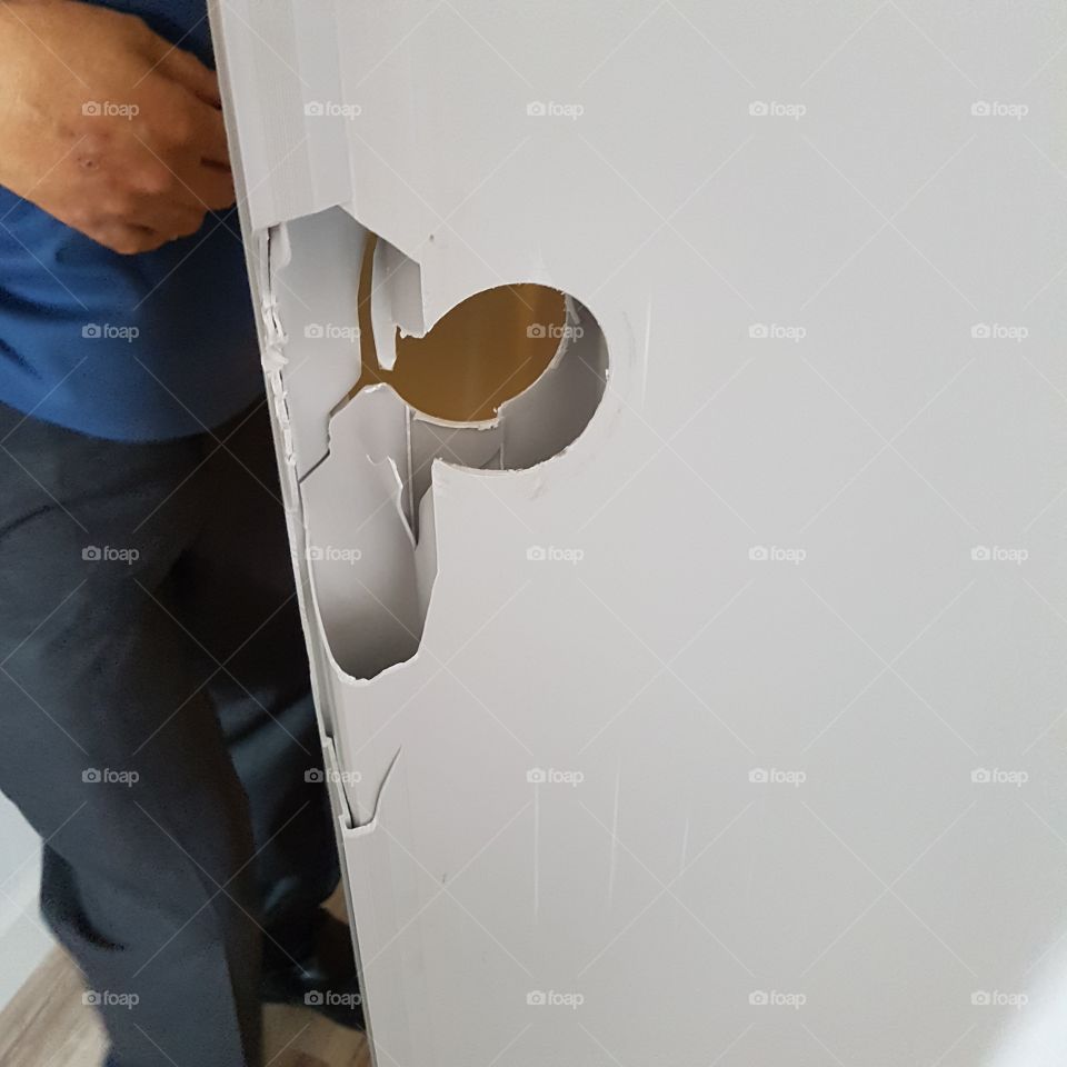 hole in a broken door without lock