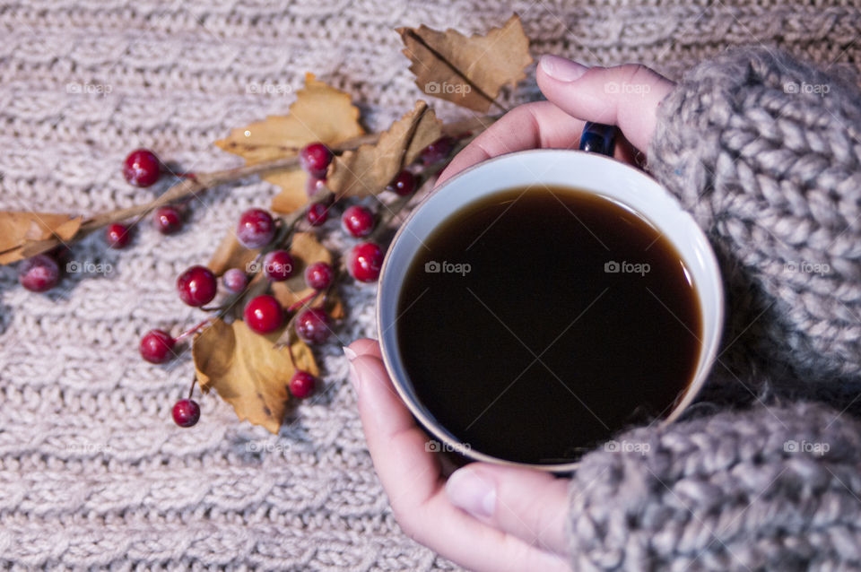 Close-up of a girl's hand with cup of coffee